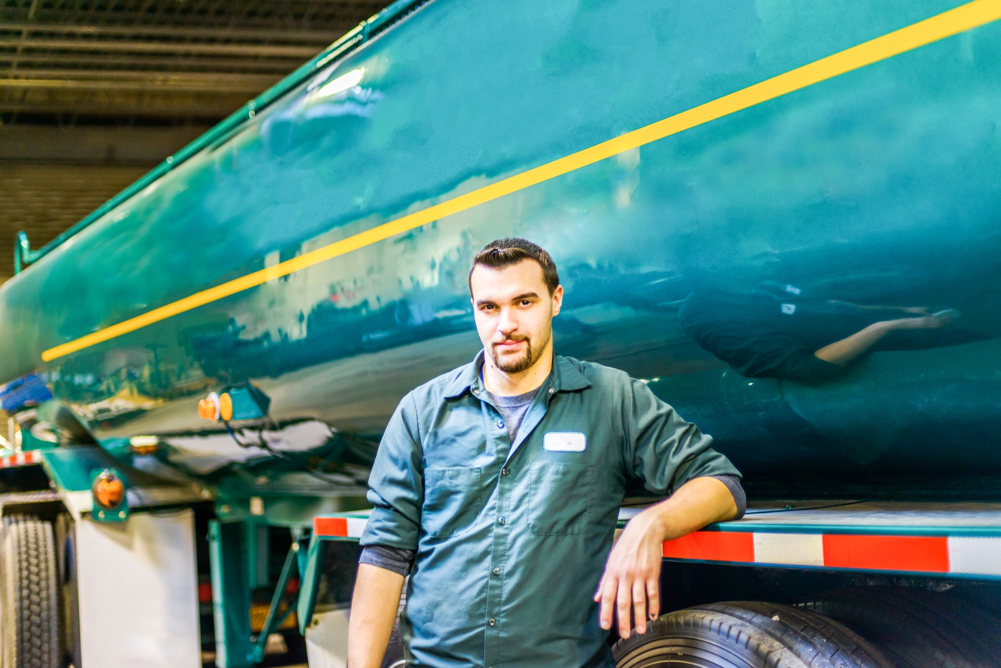 Portrait of young male trucker at biofuel industrial plant